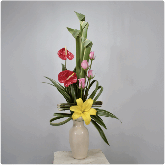 Arreglo floral contiene rosas, anturio, lilis y la base es de cerámica